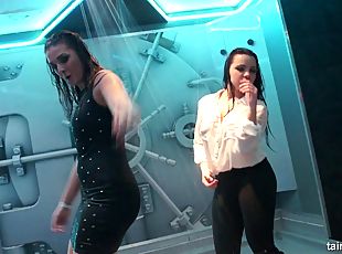 Girls dancing in a shower on stage at a wild nightclub party